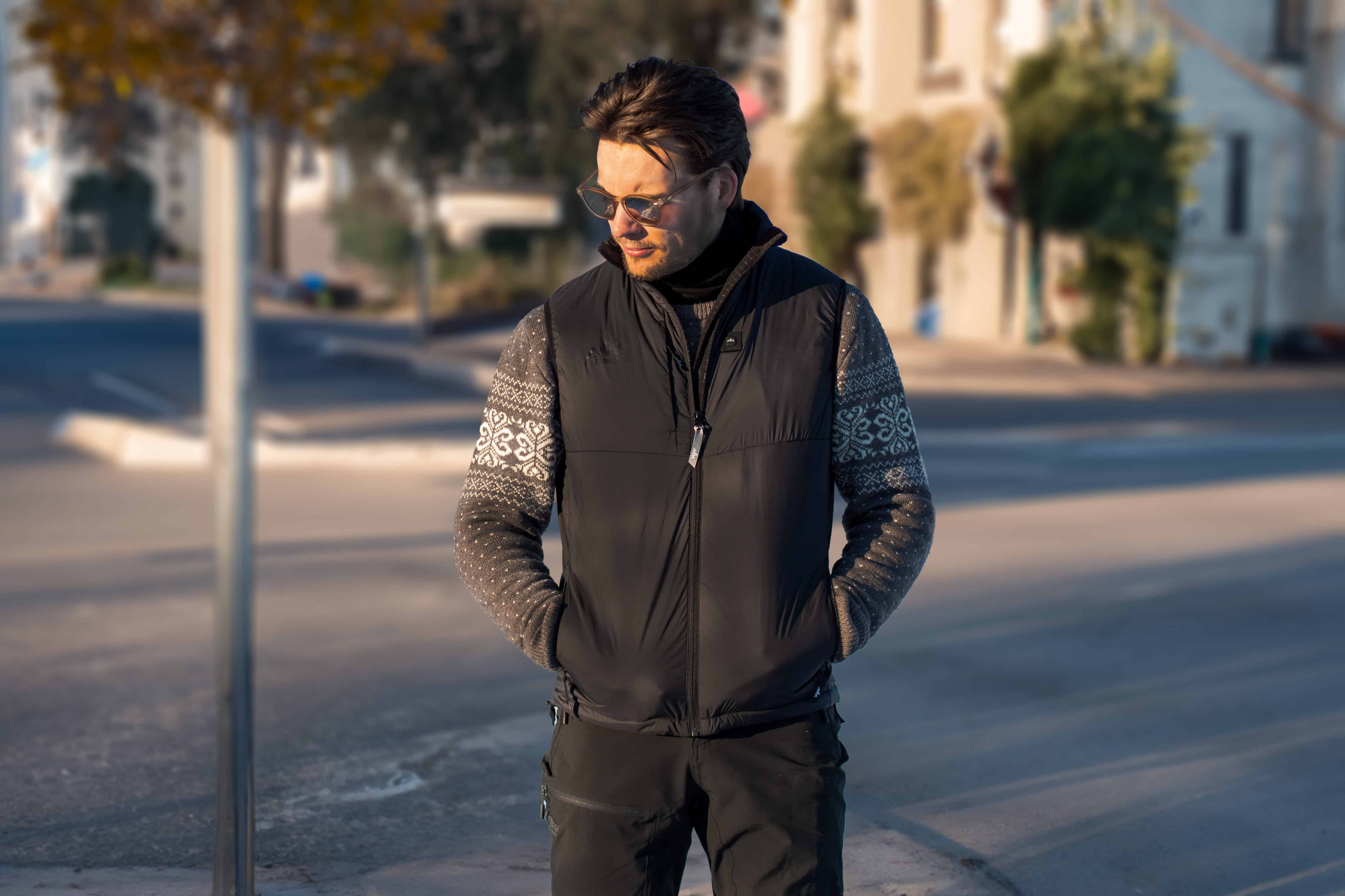 man modeling black puffer vest with integrated heating system